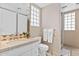 Bathroom featuring a vanity, toilet, and shower with a glass block window at 7272 N 71St St, Paradise Valley, AZ 85253