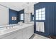 Stylish bathroom featuring double sinks, decorative wallpaper, and a well-lit vanity area at 7272 N 71St St, Paradise Valley, AZ 85253