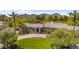 Stunning home featuring a circular driveway, vibrant flower bed, and lush landscaping with mountain views in the background at 7272 N 71St St, Paradise Valley, AZ 85253