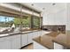 Bright kitchen with granite countertops, white cabinetry, and a view of the outside patio and chimney at 7272 N 71St St, Paradise Valley, AZ 85253