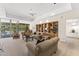 Open-concept living room featuring a built-in bookcase, recessed lighting, and access to the patio and bar at 7272 N 71St St, Paradise Valley, AZ 85253