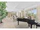 Spacious living area with a grand piano, plush seating, and views of the dining room at 7272 N 71St St, Paradise Valley, AZ 85253