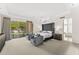 Large bedroom with gray furnishings and access to an outdoor area with pool and landscaping at 7272 N 71St St, Paradise Valley, AZ 85253