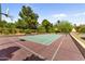 Private tennis court with basketball hoops surrounded by mature trees offering a unique athletic experience at 7272 N 71St St, Paradise Valley, AZ 85253