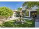 Private backyard featuring a tiered fountain, built-in barbecue, and landscaped greenery, perfect for relaxation at 7296 E San Alfredo Dr, Scottsdale, AZ 85258