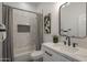 Well-lit bathroom features a white vanity with marble countertop, a tiled shower with curtain at 7296 E San Alfredo Dr, Scottsdale, AZ 85258