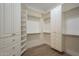 Spacious walk-in closet features custom white shelving and hanging rods at 7296 E San Alfredo Dr, Scottsdale, AZ 85258