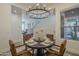 Bright dining room with a round table and stylish chandelier, perfect for entertaining at 7296 E San Alfredo Dr, Scottsdale, AZ 85258
