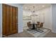 Bright dining room with modern chandelier and a designer area rug at 7296 E San Alfredo Dr, Scottsdale, AZ 85258