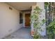 Inviting front entrance featuring a solid wood door and a manicured landscape at 7296 E San Alfredo Dr, Scottsdale, AZ 85258