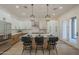 Bright, open kitchen with white cabinets, island with seating, and modern stainless steel appliances at 7296 E San Alfredo Dr, Scottsdale, AZ 85258
