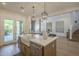 Modern kitchen island with a farmhouse sink and stainless steel appliances opens to the living room at 7296 E San Alfredo Dr, Scottsdale, AZ 85258