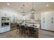 Bright kitchen features modern appliances, island seating, and stylish pendant lighting at 7296 E San Alfredo Dr, Scottsdale, AZ 85258