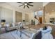 Inviting living room features stylish furniture, large windows, and an open staircase at 7296 E San Alfredo Dr, Scottsdale, AZ 85258