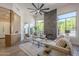 Spacious living room with a large fireplace, cozy furniture, and lots of light at 7296 E San Alfredo Dr, Scottsdale, AZ 85258