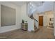 Grand foyer with staircase, light hardwood floors, and neutral decor creates a welcoming entrance at 7296 E San Alfredo Dr, Scottsdale, AZ 85258