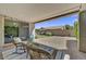 Covered patio with comfortable seating overlooking a well-manicured backyard and private outdoor space at 7407 E Portobello Ave, Mesa, AZ 85212