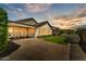 Expansive backyard at sunset with lush artificial lawn, patio, and comfortable seating, perfect for outdoor living at 7407 E Portobello Ave, Mesa, AZ 85212