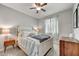 A cozy bedroom with a comfortable bed, soft lighting, and a window providing natural light at 7407 E Portobello Ave, Mesa, AZ 85212