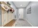 Inviting entryway featuring stylish coat rack, bench, and tiled flooring for a welcoming feel at 7407 E Portobello Ave, Mesa, AZ 85212
