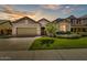 Beautiful home at sunset featuring lush lawn and well-maintained landscaping at 7407 E Portobello Ave, Mesa, AZ 85212