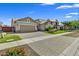 Beautiful home featuring a large driveway, lush landscaping, and a three-car garage at 7407 E Portobello Ave, Mesa, AZ 85212