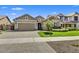 Charming single-story home features manicured lawn, brick driveway, and a two-car garage at 7407 E Portobello Ave, Mesa, AZ 85212