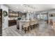 Modern kitchen with dark cabinets, granite countertops, stainless steel appliances, and large island at 7407 E Portobello Ave, Mesa, AZ 85212