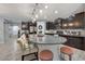 Open kitchen featuring a spacious island, granite countertops, modern appliances, and plenty of cabinets at 7407 E Portobello Ave, Mesa, AZ 85212