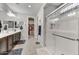 Well-lit main bathroom featuring double vanity, walk-in shower, and closet access at 7407 E Portobello Ave, Mesa, AZ 85212