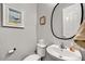 Neat powder room boasting a round mirror, basin sink and clean neutral tones at 7407 E Portobello Ave, Mesa, AZ 85212