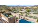 Aerial view of a backyard with a swimming pool, hot tub, balcony, and desert landscaping at 7754 E Wolf Canyon St, Mesa, AZ 85207