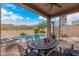 Inviting backyard with a covered patio, dining area, spiral staircase and swimming pool at 7754 E Wolf Canyon St, Mesa, AZ 85207