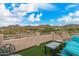 Relaxing balcony with comfortable seating, tables, and panoramic views of the desert landscape at 7754 E Wolf Canyon St, Mesa, AZ 85207