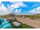 Relaxing balcony with comfortable seating, tables, and panoramic views of the desert landscape at 7754 E Wolf Canyon St, Mesa, AZ 85207
