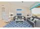 Inviting living room with vaulted ceiling, tile floors, and access to the outdoor space at 7754 E Wolf Canyon St, Mesa, AZ 85207