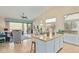 Bright, open floor plan with a modern kitchen island overlooking the living area at 7754 E Wolf Canyon St, Mesa, AZ 85207