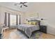 Comfortable bedroom with large windows, tile floors and a ceiling fan at 7754 E Wolf Canyon St, Mesa, AZ 85207