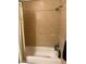A full bathroom showcases a shower/tub, tile walls, and a neutral shower curtain at 7901 W Tuckey Ln, Glendale, AZ 85303