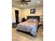 Comfortable bedroom features wood-look floors, neutral walls, and a cozy bed with updated decor at 7901 W Tuckey Ln, Glendale, AZ 85303