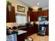 Well-lit kitchen featuring granite counters, modern appliances and beautiful wooden cabinets at 7901 W Tuckey Ln, Glendale, AZ 85303