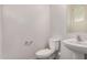Modern powder room with pedestal sink, toilet, and neutral color scheme at 829 E Agua Fria Ln, Avondale, AZ 85323