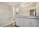 Bright bathroom with a double sink vanity, bath tub, and window at 829 E Agua Fria Ln, Avondale, AZ 85323