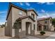 Inviting two-story home with a tiled roof, arched entryway, and neutral stucco in a well-maintained community at 829 E Agua Fria Ln, Avondale, AZ 85323