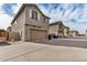Row of two-story houses with driveways and garages on a sunny day at 829 E Agua Fria Ln, Avondale, AZ 85323