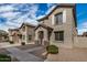 A charming two-story home with neutral stucco, tiled roof, and simple landscaping under a partly cloudy sky at 829 E Agua Fria Ln, Avondale, AZ 85323