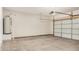 Spacious garage featuring an overhead door and a water heater at 829 E Agua Fria Ln, Avondale, AZ 85323