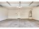 Empty garage with white walls and door to the home at 829 E Agua Fria Ln, Avondale, AZ 85323