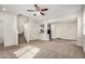 Open living area with carpet, stairs, and views into the kitchen, offering a bright and airy atmosphere at 829 E Agua Fria Ln, Avondale, AZ 85323