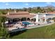 Aerial view of an estate featuring a pool, outdoor seating, and lush landscaping with mountain views at 8515 E Sutton Dr, Scottsdale, AZ 85260